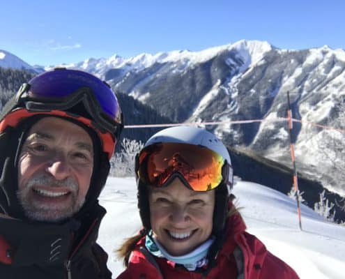 two smiling skiers